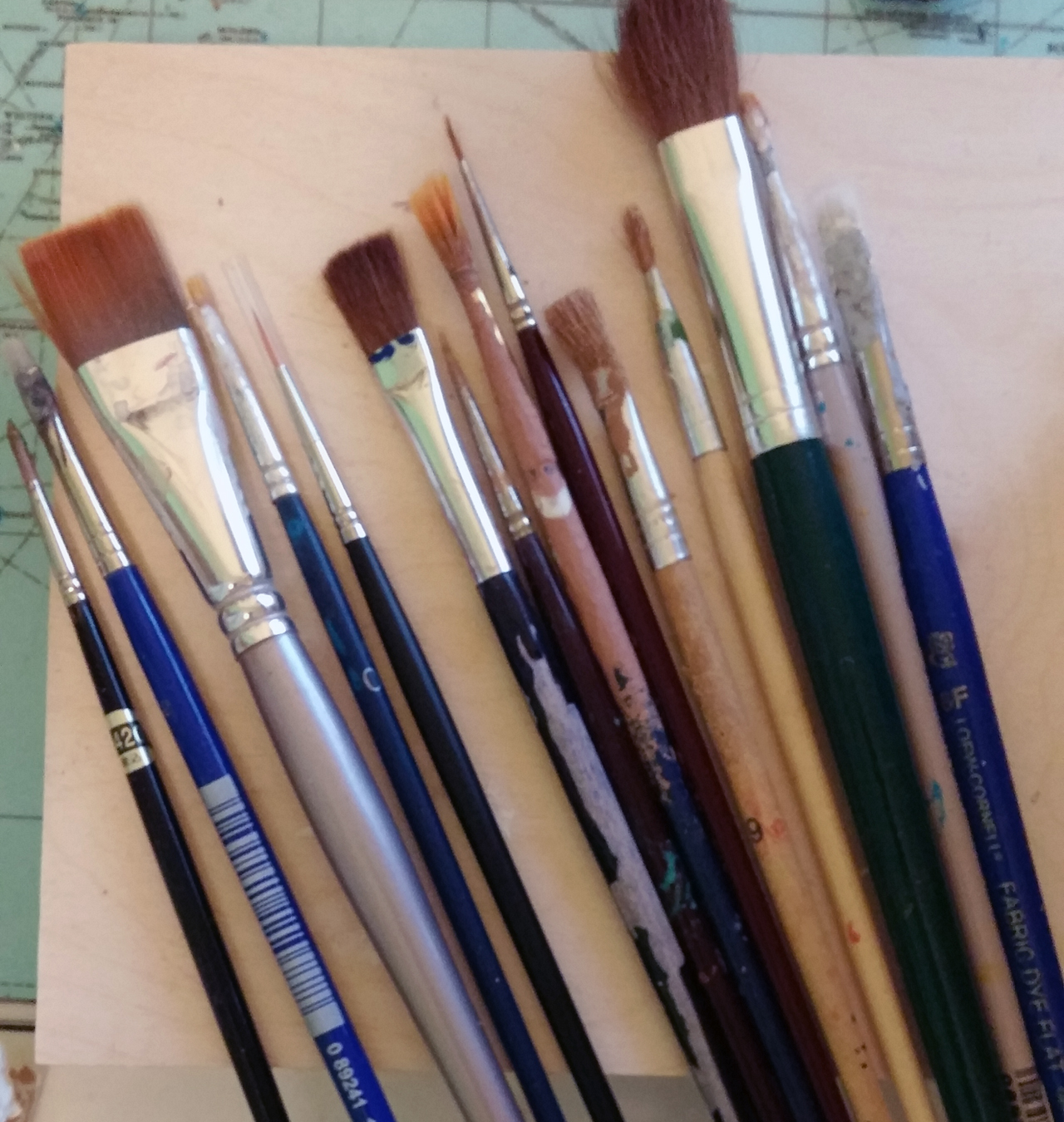assorted paintbrushes on desk