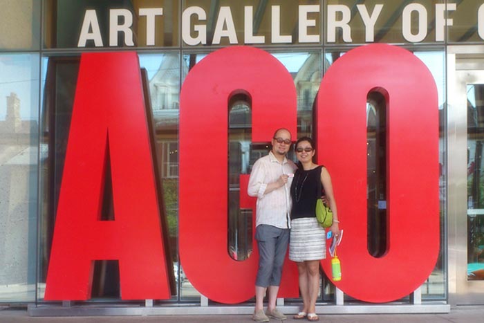 Artist Marten Go and wife, Yoko Tsumagari standing in front of The Art Gallery of Ontario in Toronto, Canada