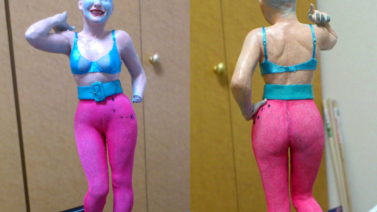 Two images in a medium close up of the miniature statue wearing matching blue bra to belt