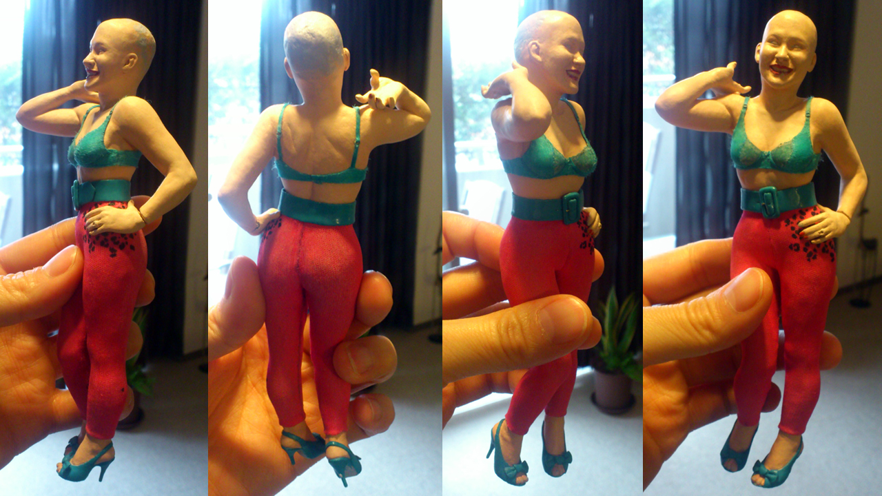 Four images of miniature statue standing wearing blue bra and pink tights without hair piece