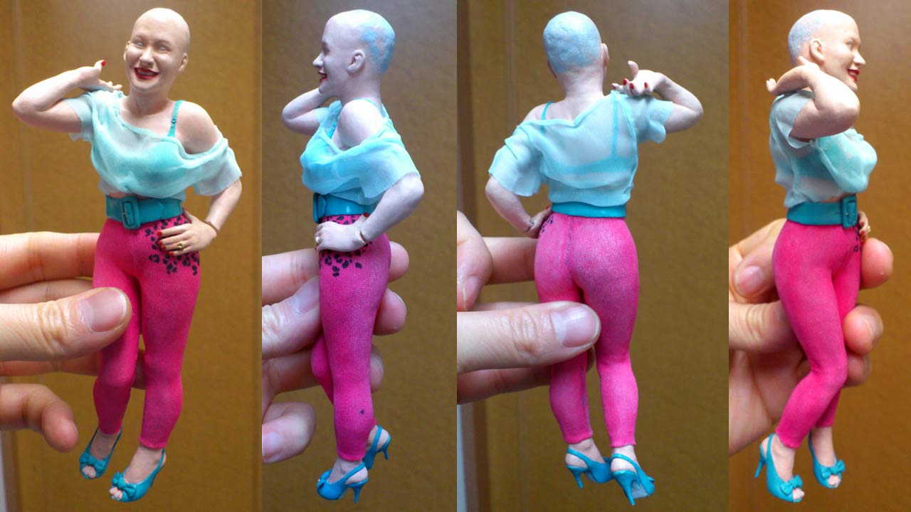Four images of miniature statue fully clothed with blue see-through blouse without hair piece