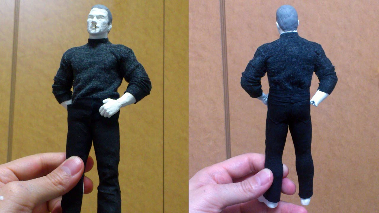Two images side by side in a medium close up of the 7 inch statue standing fully clothed in gray short turtle neck sweater and black tight jeans