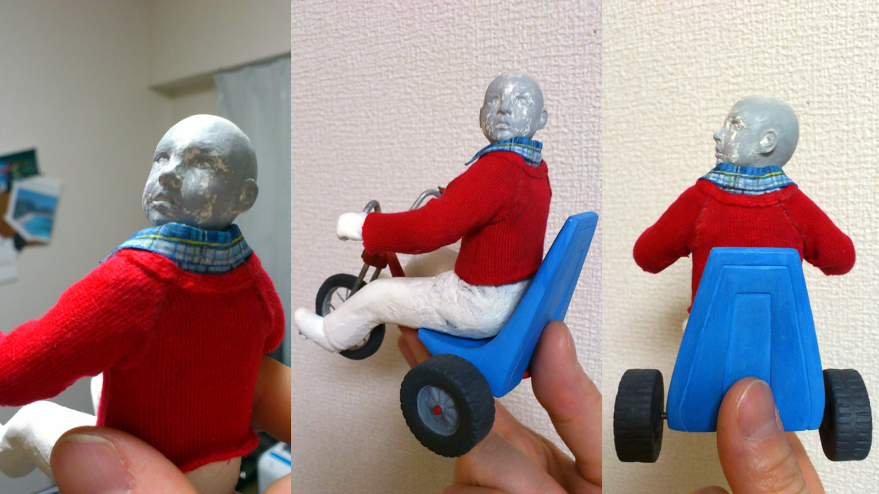 Three images in close up of clay statue on a tricycle in a red sweater