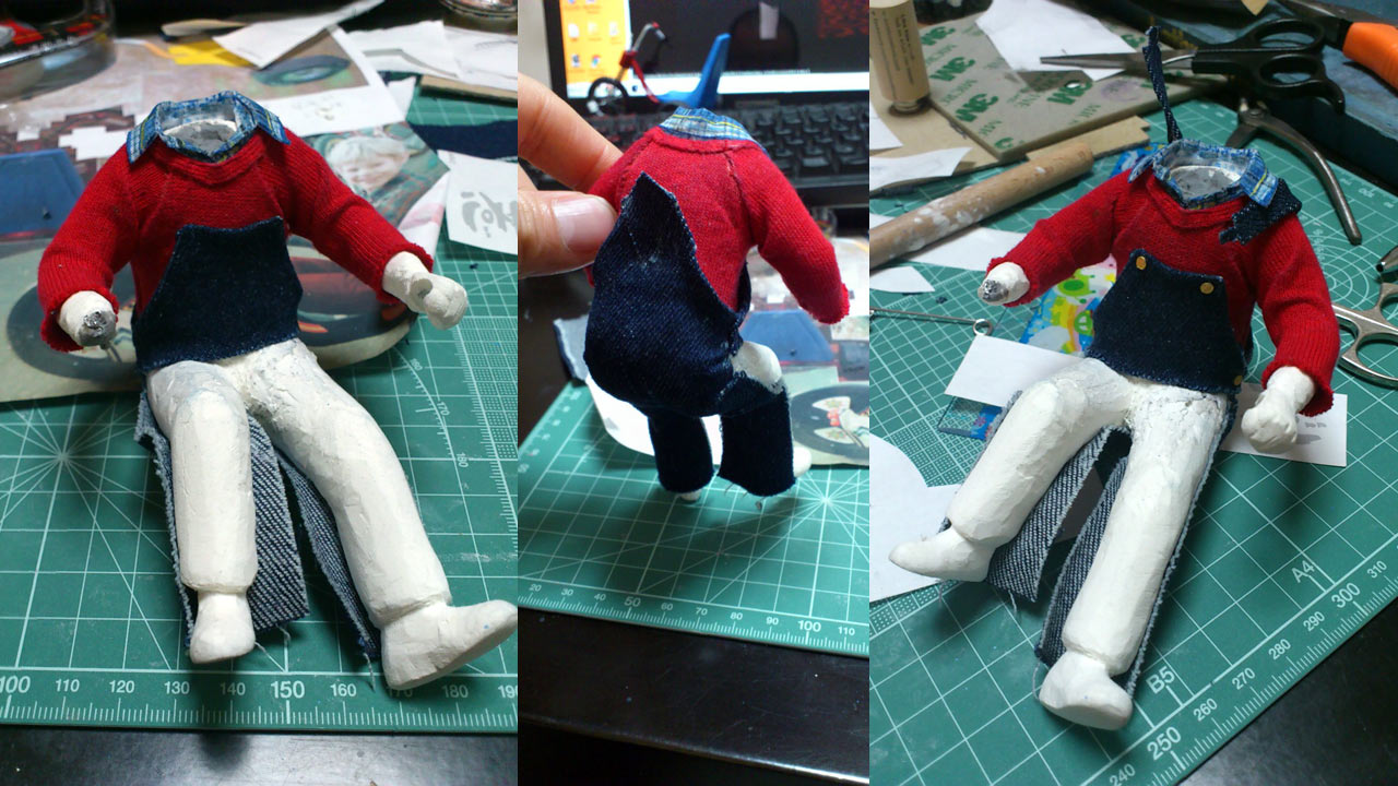 Three images of the miniature statue in various angles getting pants made