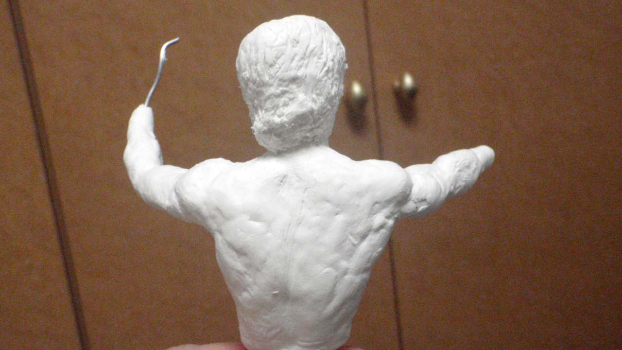 One image of the back torso and head with hair made in stone clay with aluminum wires for hands