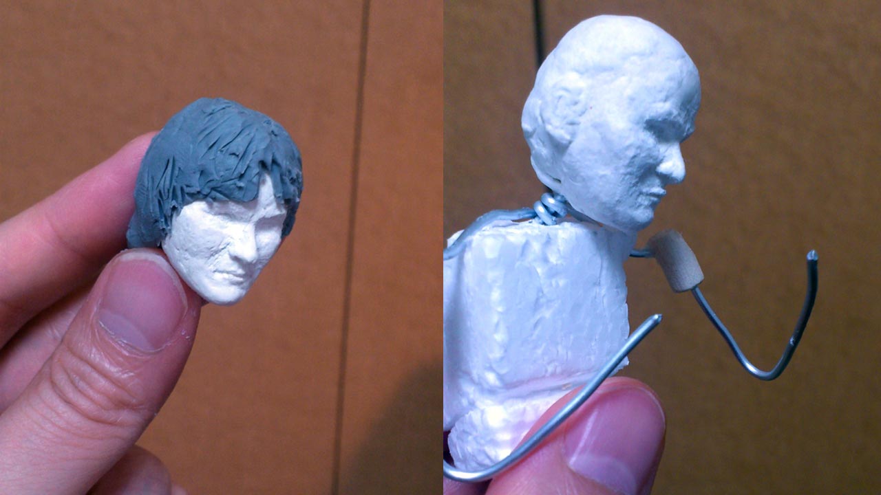 Two close up images side by side of the miniature refined sculpted head of Mondale's Henchman with pronounced facial details and stand-in hair and aluminum wire armature with styrofoam